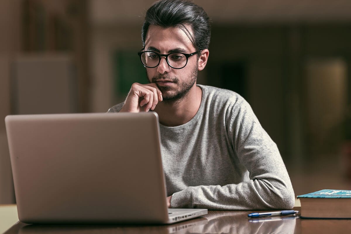 A man at his computer, pausing to think as artificial intelligence reshapes how we work, make decisions, and navigate a rapidly changing future.